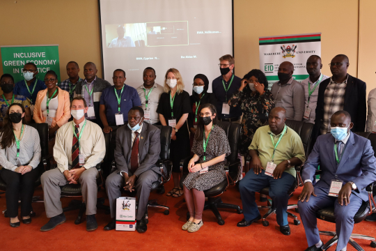 Asection of the IGE fellows posing for a group photo with Collins Oloya (3rd) after the closing ceremony.