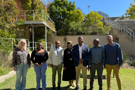 Picture of the workshop attendees standing outside the UCT School of Economics building