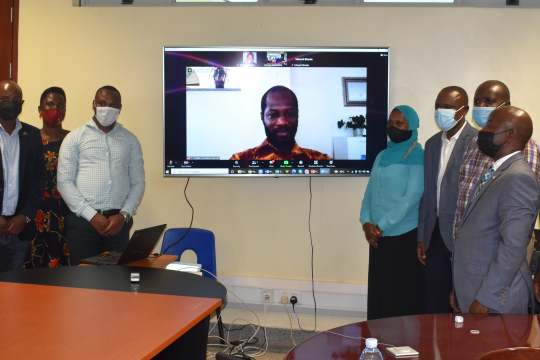 Grantees, the Chief Guest Prof. Eria Hisali and center staff pose for a group photo with EfD Global Hub Research Manager Dr. Franklin Amuakwa Mensah online