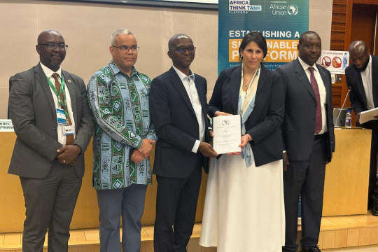 Five people standing, someone collecting a certificate