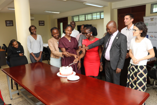 Centre Director Prof. Edward Bbaale and staff cutting a cake in honor Internee Ruth Asiimwe for the job welldone :Photo by Jane Anyango