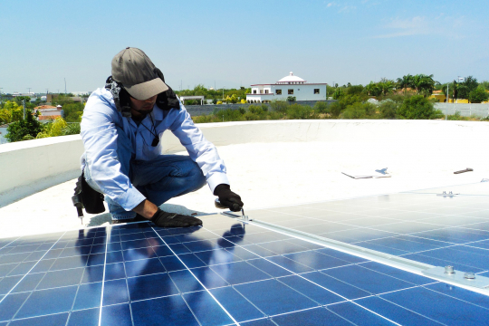 Man installing solar panels