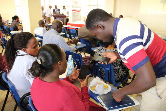 Some participants being aided to carry out the survey using mobile smart phones. Photo: EfD-Mak centre