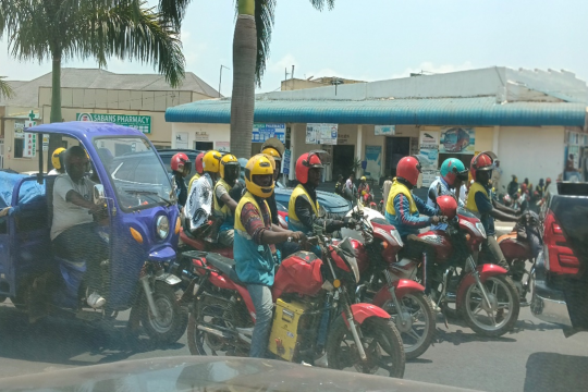 People riding converted electric motorbikes in Rwanda
