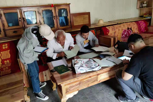 Farmers in Gansu Province showing interviewers their Forest Rights Certificates