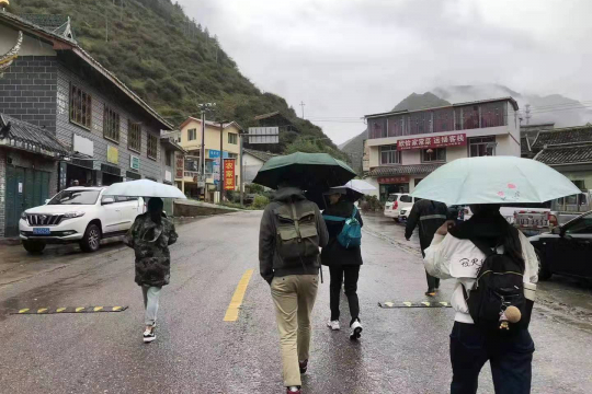 Interviewers walking in the Tibetan area village