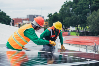 Technicians installing solar panels