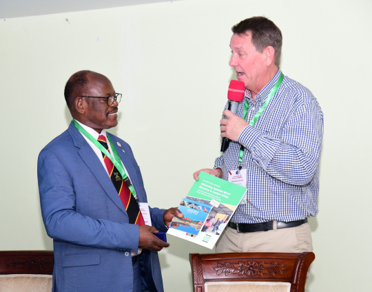 Prof. Barnabss Nawangwe receives a gift  (report on Inclusive Green Economy in East Africa) from Anders Ekbom after the opening session