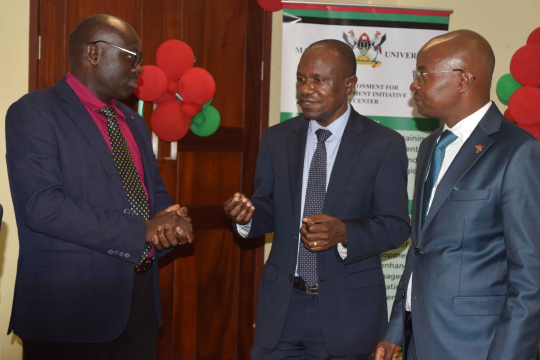 Assistant Commissioner Ministry of Finance Dr. Mugume Koojo, Prof. Eria Hisali and Prof Edward Bbaale interacting after the launch.JPG