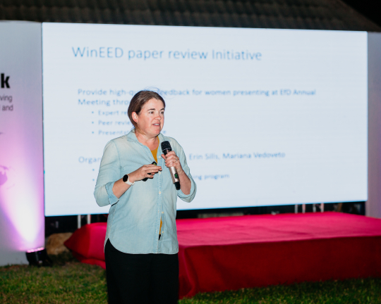 Katrina Mullan in front of her presentation