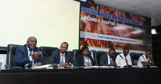 Dr. John Seruyange speaking during the panel discussions at the National Water and Swewarage Corporation offices