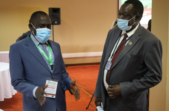 EfD-Mak IGE program coordinator Peter Babyenda interacts with the Director Collins Oloya after the closing ceremony