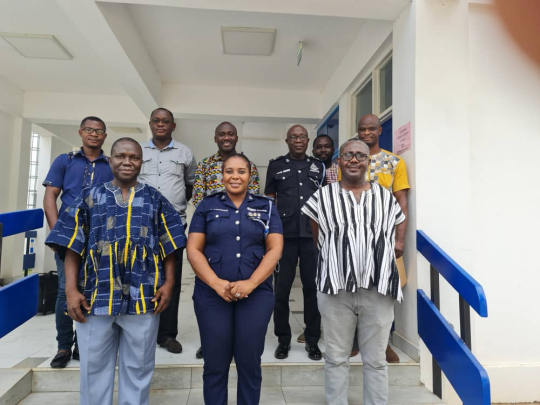 Participants standing for a group photo at the end of the meeting
