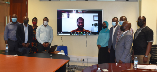 Grantees and Chief Guest Dr. Eria Hisali,  centre staff  pose for a group photo with the EfD Global Hub  Research Manager Dr. Franklin Amuakwa-Mensah online 