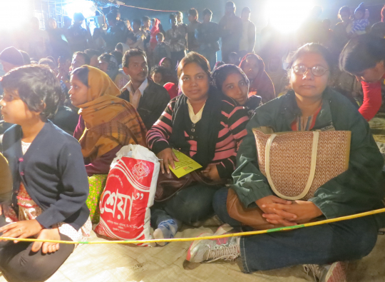 villagers watching the play