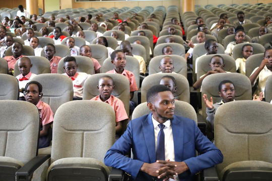 John Roberts Tenywa seated with pupils: Photo by EfD-Mak
