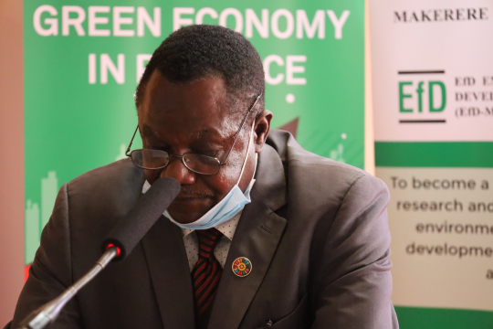 Mr. Collins Oloya reading the speech for the minister during the closing ceremony