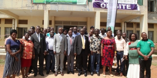 Mukono RDC Fred Bamwine (in black suit) takes a photo with Makerere staff and Mukono district leadership after the dialogue