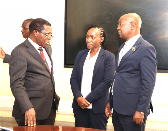Prof. Buyinza interacting with the center Deputy Director Alice Turinawe and Director Edward Bbaale