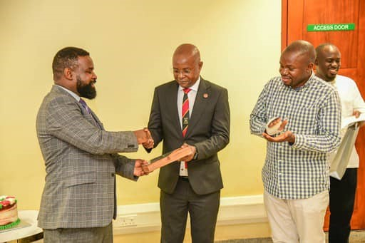 Robert Wamala Hands over the plague to Edward Bbaale.