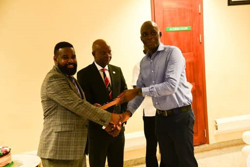 Robert Wamala hands over the plague to Nickolas Kilimani