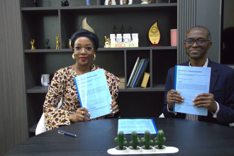 A woman and a man showing a signed contract