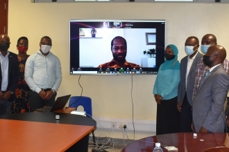 Grantees, the Chief Guest Prof. Eria Hisali and center staff pose for a group photo with EfD Global Hub Research Manager Dr. Franklin Amuakwa Mensah online