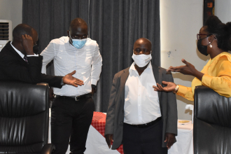 Policy Engagement Specialist  Mr. Peter Babyenda who is in charge of coordinating the IGE program in Uganda interacts with some participants at Hotel Protea Kampala
