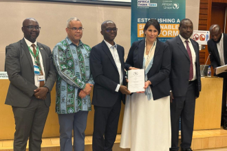 Five people standing, someone collecting a certificate