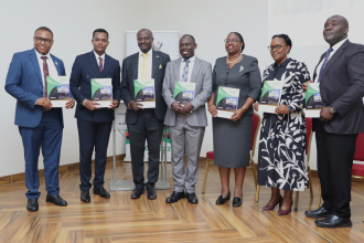Panelists and some speakers posing for a photo with the GRO Annual report.