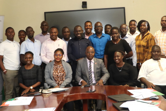 Participants posing for a group photo with the Centre Director Edward Bbaale (3rd front row) after the opening ceremony